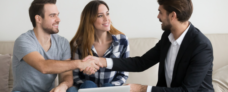 Property Management A couple shaking hands with a suited professional, suggesting a positive meeting or agreement